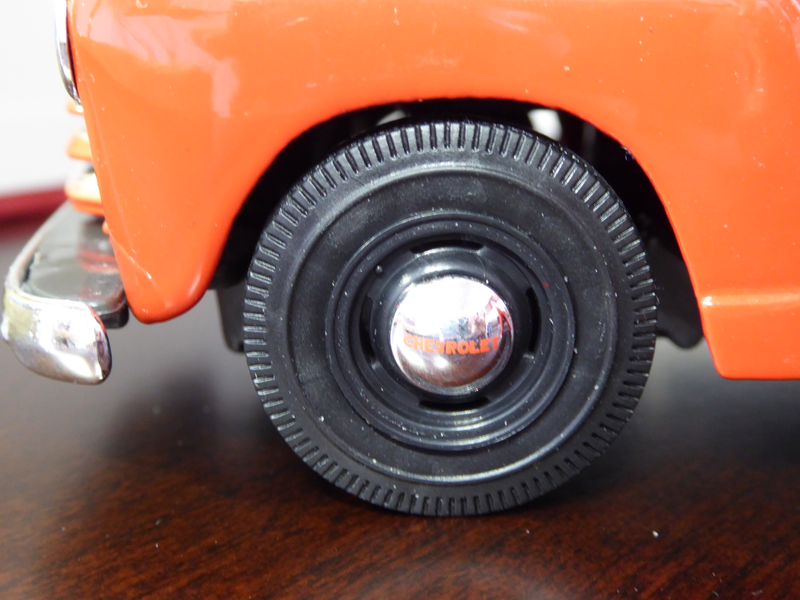 Black wall tire with red Chevrolet letter on hub cap. Tire width seems to be based on stock. Has working steering as an added bonus.